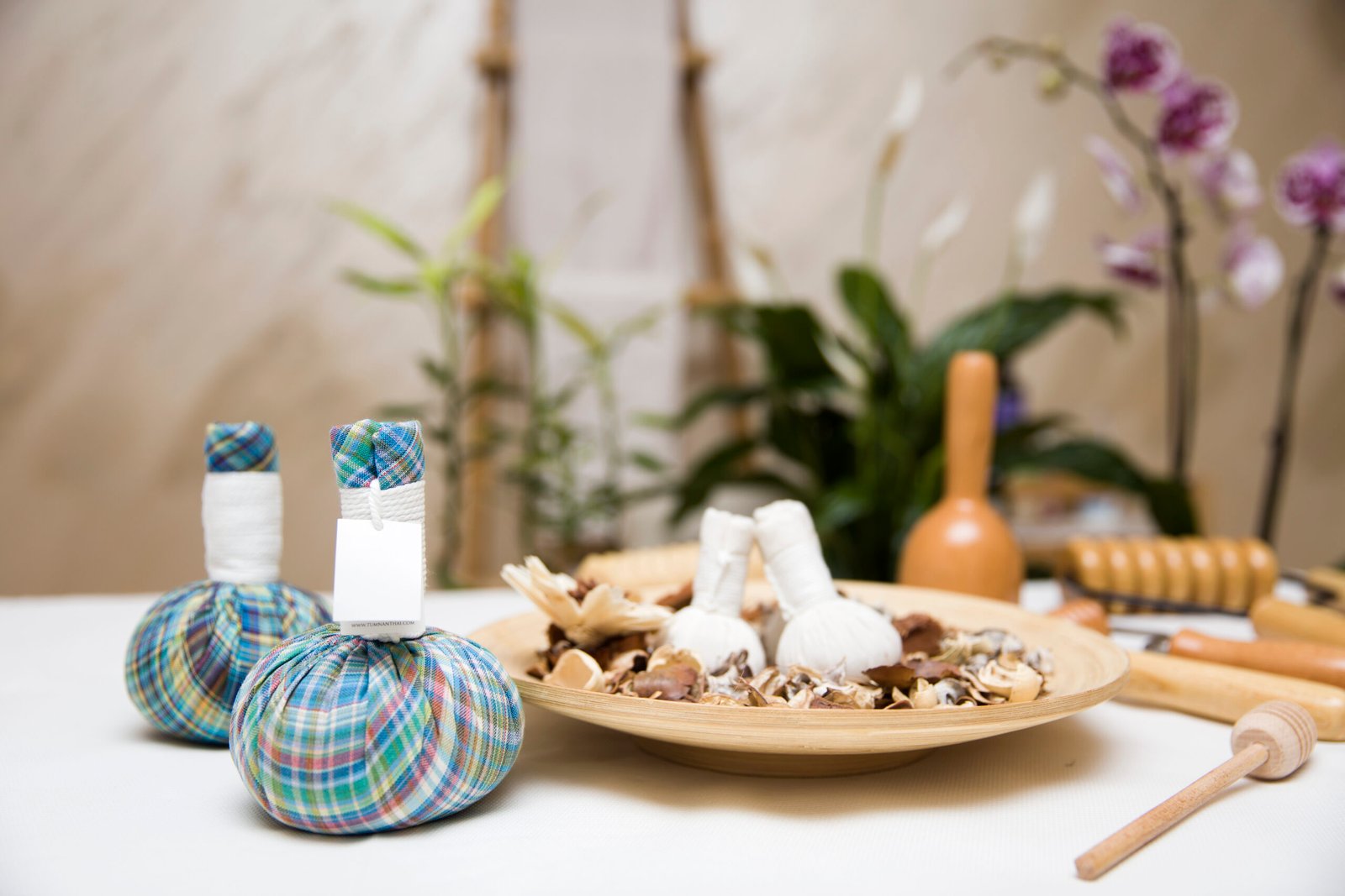 Aromatic herbal massage bags with herbs and wooden maderotherapy